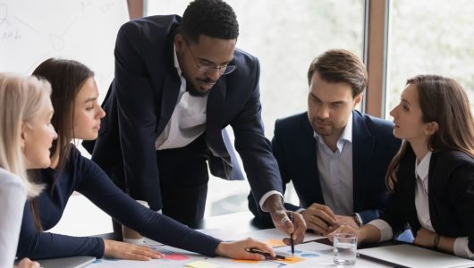 Focused,African,American,Business,Leader,And,Employees,Discussing,Project,On Focused,African,American,Business,Leader,And,Employees,Discussing,Project,On
